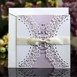 Laser cut wedding invitation set with floral cover, silk bow and elegant RSVP card