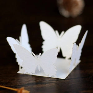 Macro shot of laser-cut butterfly decorations with delicate lace pattern for candy boxes