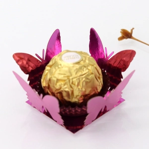 Detail of pink metallic laser cut butterfly chocolate box with hollow lace pattern