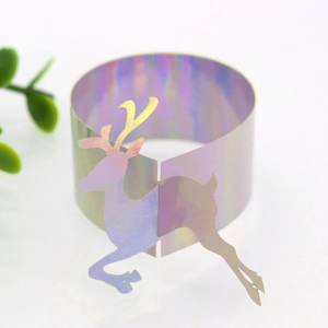 Close-up of holographic paper reindeer napkin ring for Christmas table decor