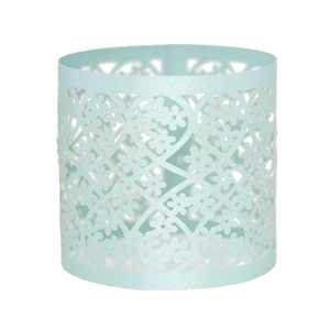 Close-up of mint blue napkin ring featuring laser-cut floral and heart patterns