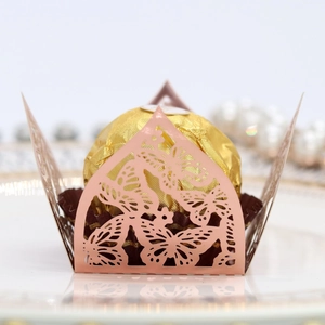 Detail of pink laser-cut butterfly chocolate box with pearlescent finish for weddings
