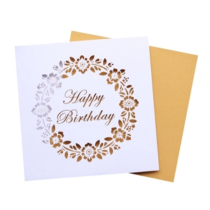 Detail view of laser-cut floral birthday card with artistic Happy Birthday lettering