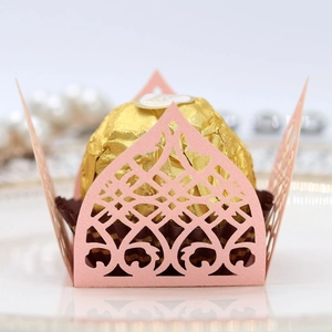 Detailed laser-cut pink pearlescent paper wrapper with elegant lace patterns for chocolates