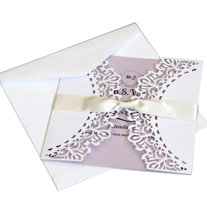 Elegant white laser-cut wedding invitation with purple card and silk ribbon bow