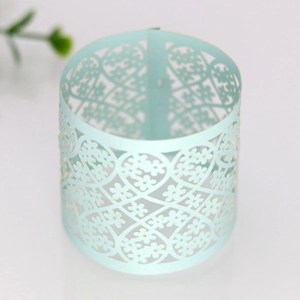 Detailed laser-cut mint blue napkin ring featuring intricate floral and heart lace patterns