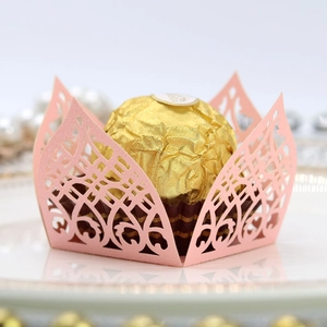 Detail of pink laser-cut pearlescent paper candy box with intricate lace pattern