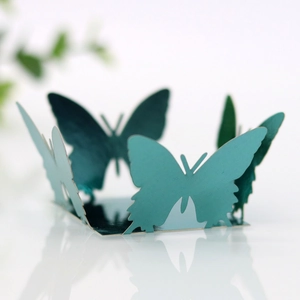 Detail of teal butterfly hollow-out candy box with pearlescent finish and 3D design