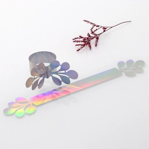 Detailed holographic napkin ring featuring laser-cut leaf pattern for wedding decor