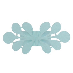 Macro shot of light blue laser-cut paper napkin ring with shimmering glitter coating