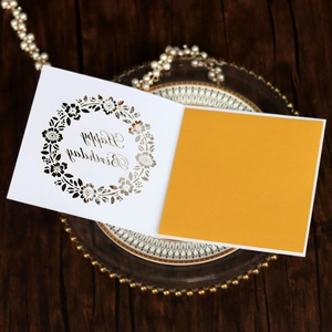 Detail of laser-cut floral pattern and Happy Birthday text on stylish greeting card