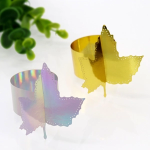 Golden and iridescent maple leaf paper napkin rings with cutout details for party decor