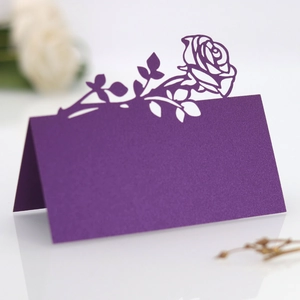 Detail of purple laser-cut rose place card with elegant pearlescent finish and texture