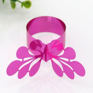 Detailed view of magenta butterfly napkin ring with laser cut pattern for table setting