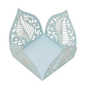 Detail of light blue laser-cut pearlescent paper wrapper with intricate leaf patterns
