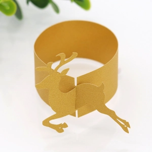 Macro shot of gold pearlescent paper napkin ring with a reindeer silhouette