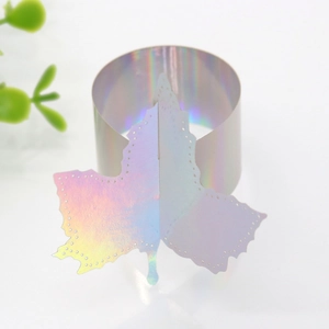 Macro detail of laser iridescent maple leaf napkin ring with holographic mirror finish