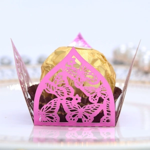 Macro detail of laser-cut pink butterfly chocolate wrapper for wedding party favors