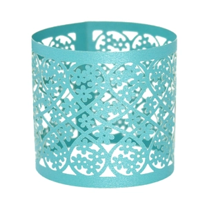 Detailed view of teal pearlescent paper napkin ring with laser-cut floral patterns