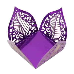 Close-up of laser-cut purple hollow leaf pattern on a square metallic gift box