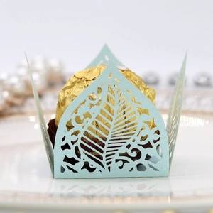 Macro shot of laser-cut pearl paper candy box with leaf pattern in light blue
