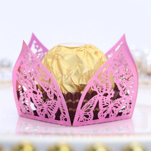 Close-up of laser-cut pink butterfly candy box with hollow design and floral patterns