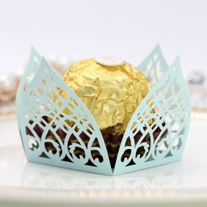 Detail of light blue laser-cut crown candy box with elegant floral vine hollow pattern