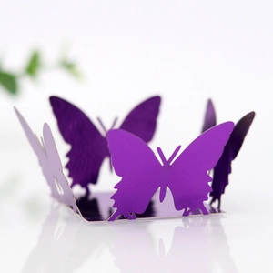 Macro shot of purple laser-cut butterfly cupcake wrapper with premium pearlescent finish