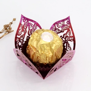 Macro shot of laser-cut butterfly purple paper favor box with chocolate decoration