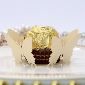 Macro shot of laser-cut 3D butterfly paper lace wrapper for chocolates and candies