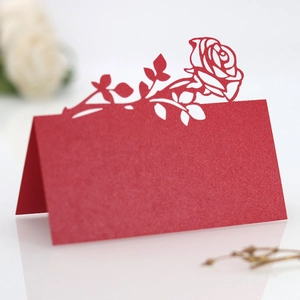 Detailed laser-cut rose hollow design on premium red paper wedding place cards