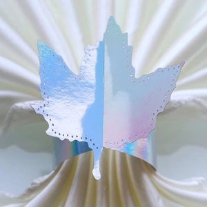 Close-up of holographic maple leaf napkin ring with precision laser-cut perforated edges