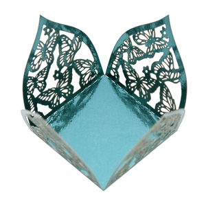 Detail of laser-cut butterfly candy box in turquoise pearlescent paper for weddings