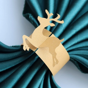 Detail showing golden glitter laser-cut reindeer paper napkin rings for holiday table decor