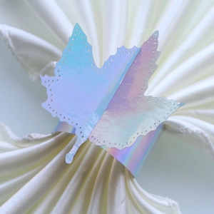 Macro detail of laser-cut maple leaf napkin ring with holographic mirror finish