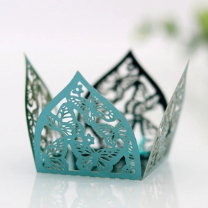 Detailed laser-cut butterfly and floral patterns on teal wedding favor gift box