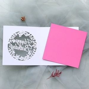 Detail of laser-cut Happy Birthday card with pink insert on elegant tulle background