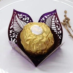 Detail of purple laser-cut leaf pattern chocolate wrapper with metallic pearlescent finish