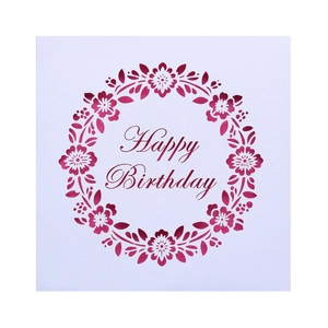 Macro detail of laser cut floral wreath and Happy Birthday text on white square card