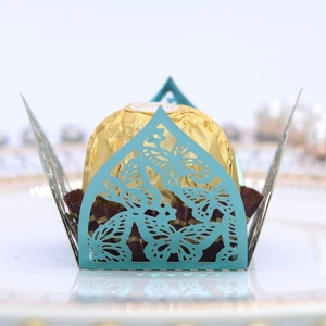 Detail of laser-cut butterfly chocolate wrapper in blue for wedding party favors