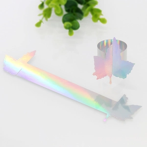 Detail of laser-cut maple leaf paper napkin rings with holographic iridescent mirror finish