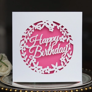 Detailed laser-cut floral pattern and Happy Birthday script on a pink layered card