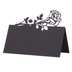 Detailed laser-cut black paper place card with rose design for wedding table setting