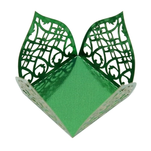 Close-up of laser-cut European vine pattern on shiny green metallic candy box