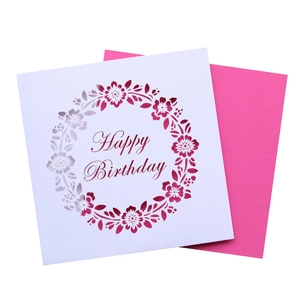Detailed laser cut white floral wreath birthday card with vibrant magenta insert
