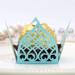 Close-up of light blue laser-cut hollow candy wrapper with elegant geometric lace design