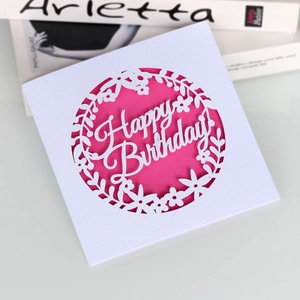 Laser-cut Happy Birthday card with pink insert and white floral wreath design