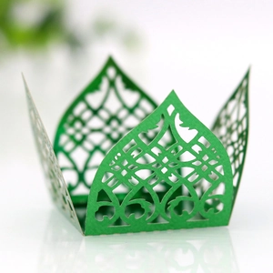 Close-up of green laser-cut wedding candy box with elegant floral lace pattern
