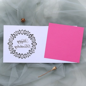 Detailed laser-cut floral pattern on a Happy Birthday card with pink inner paper inlay