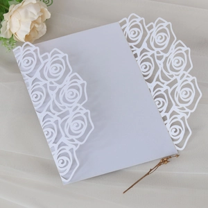 Detail of white laser-cut rose hollow invitation sleeve with elegant lace patterns